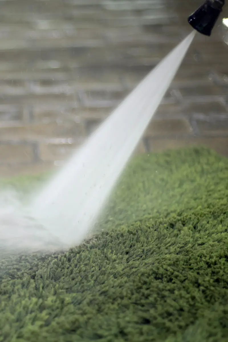 Cleaning artificial grass